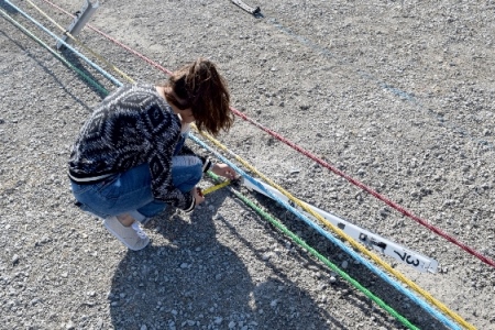 student measuring pipes